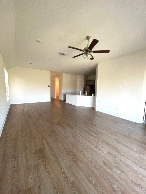 unfurnished living room with ceiling fan, hardwood / wood-style flooring, and a textured ceiling