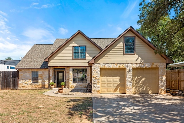 view of front of home with a front yard and a garage