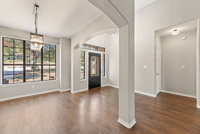 entrance foyer featuring a notable chandelier and dark hardwood / wood-style floors