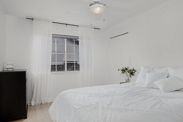 bedroom with light hardwood / wood-style flooring and ceiling fan