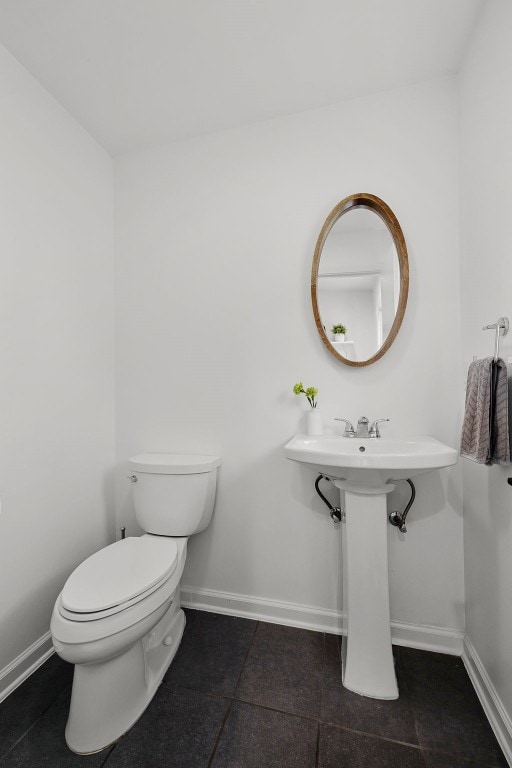 bathroom featuring toilet and tile patterned flooring