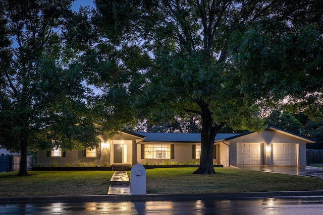 view of front of house featuring a front lawn and a garage