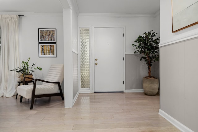 entryway with crown molding and light wood-type flooring