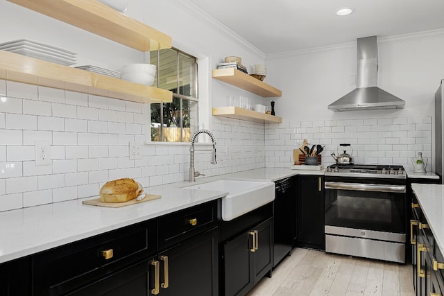 kitchen with wall chimney exhaust hood, light hardwood / wood-style flooring, sink, light stone countertops, and electric stove