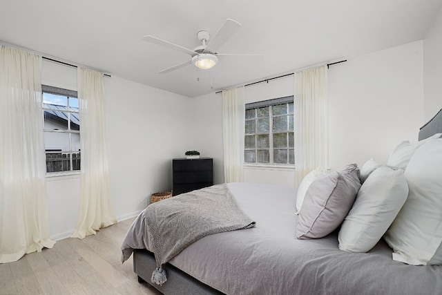 bedroom with light wood-type flooring and ceiling fan