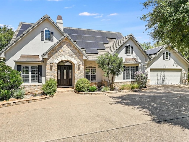 view of front of house featuring solar panels and a garage