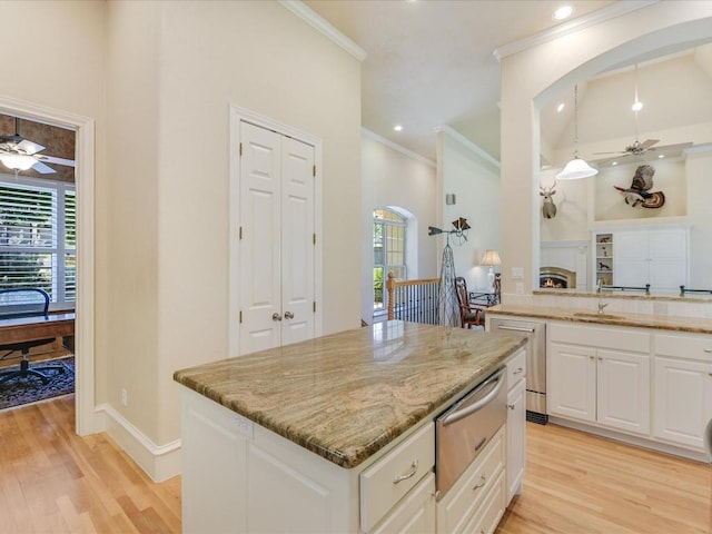 kitchen featuring white cabinetry, light hardwood / wood-style flooring, ceiling fan, and decorative light fixtures