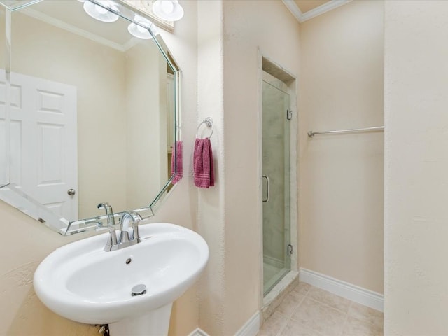 bathroom featuring tile patterned floors, a shower with shower door, ornamental molding, and sink