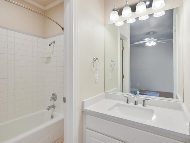 bathroom with vanity, tiled shower / bath combo, and ceiling fan