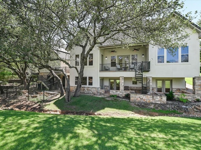 back of house featuring ceiling fan and a lawn