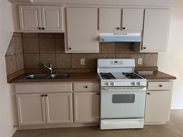 kitchen with decorative backsplash, white cabinets, gas range gas stove, and sink