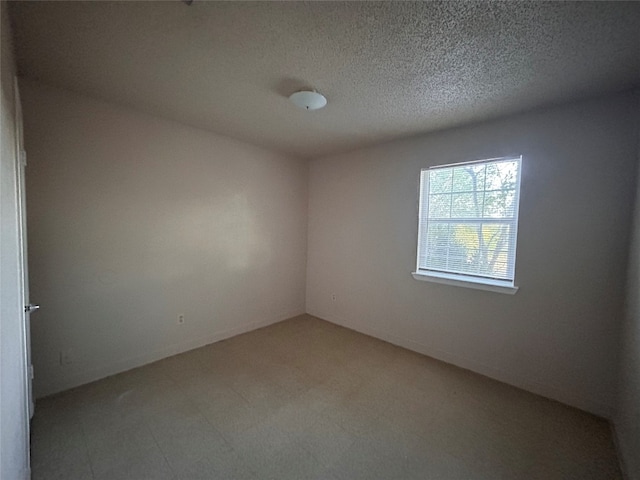 empty room with a textured ceiling