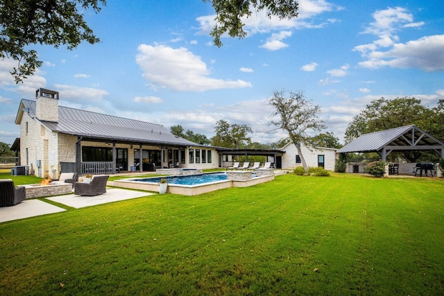 rear view of property with central AC unit, a lawn, and a patio area