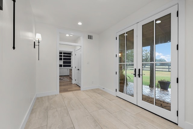 interior space featuring light hardwood / wood-style floors and french doors