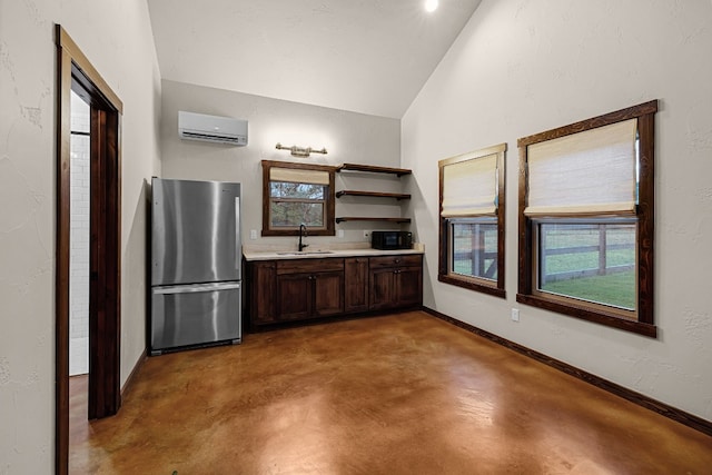 interior space featuring vanity, lofted ceiling, concrete floors, and an AC wall unit