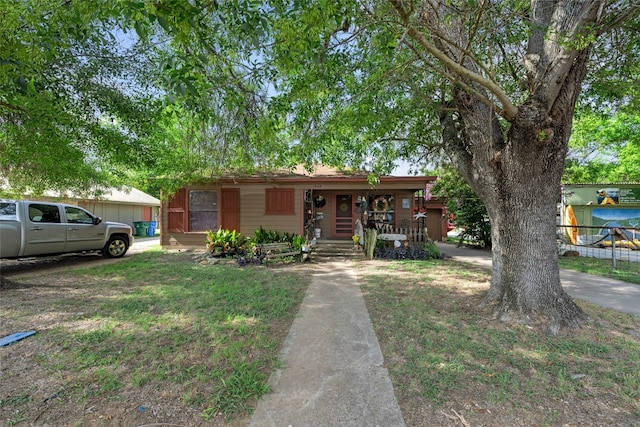 ranch-style house with a front yard and a porch