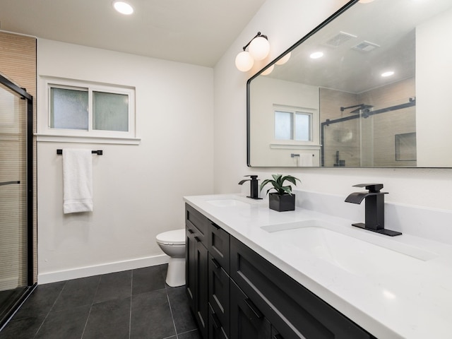 bathroom featuring tile patterned floors, vanity, toilet, and walk in shower