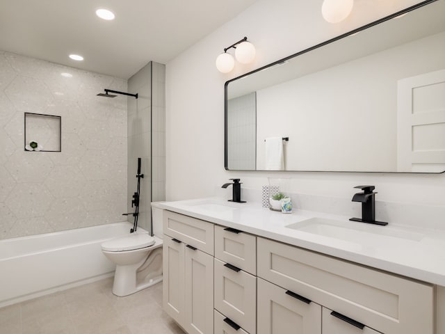 full bathroom featuring tile patterned flooring, toilet, vanity, and tiled shower / bath