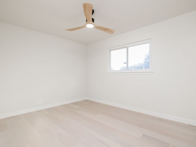 empty room with light hardwood / wood-style flooring and ceiling fan