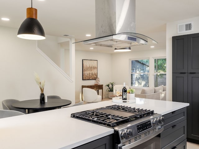 kitchen with island range hood, high end range, and decorative light fixtures