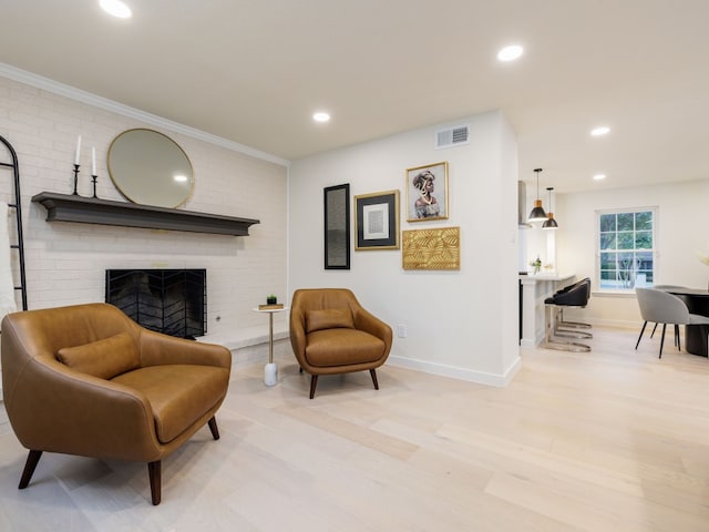 sitting room featuring a fireplace and light hardwood / wood-style floors