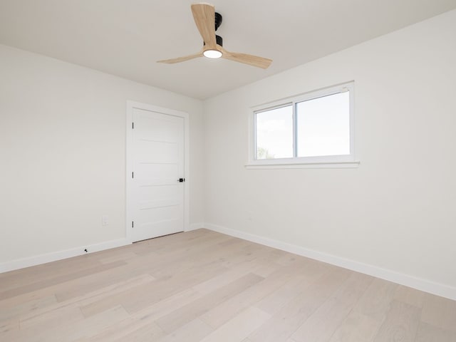 spare room with light hardwood / wood-style floors and ceiling fan