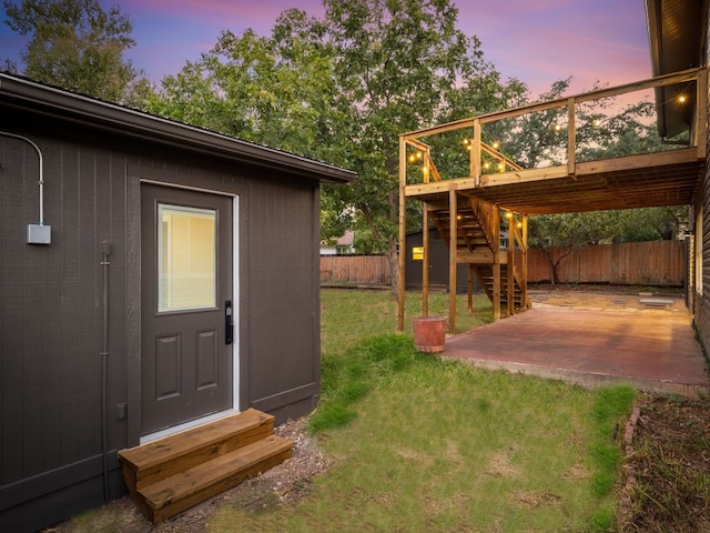 yard at dusk with a patio and a deck