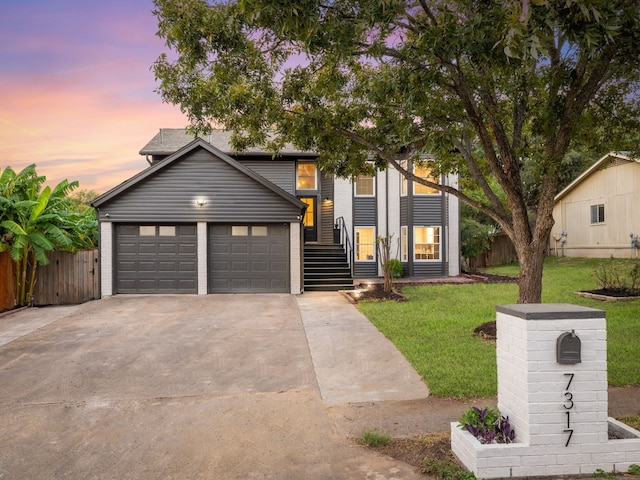 view of front of property featuring a lawn and a garage