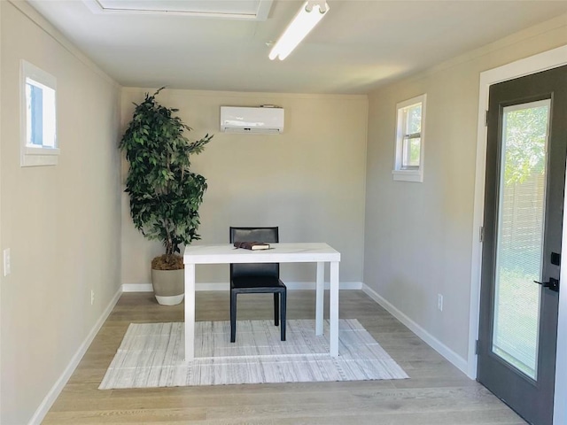 office area featuring light hardwood / wood-style flooring and an AC wall unit