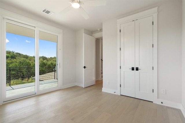 unfurnished bedroom featuring ceiling fan, access to exterior, and light hardwood / wood-style flooring