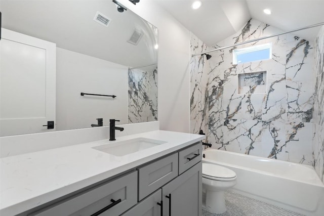 full bathroom featuring tiled shower / bath combo, toilet, vanity, and vaulted ceiling