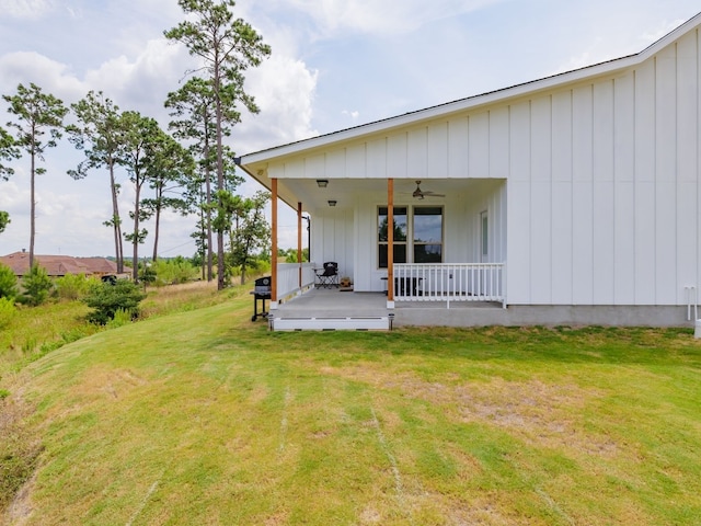 back of property featuring a yard and ceiling fan