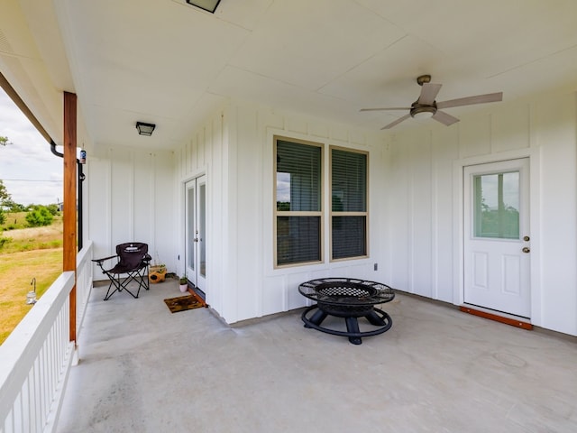 view of patio featuring ceiling fan and a fire pit