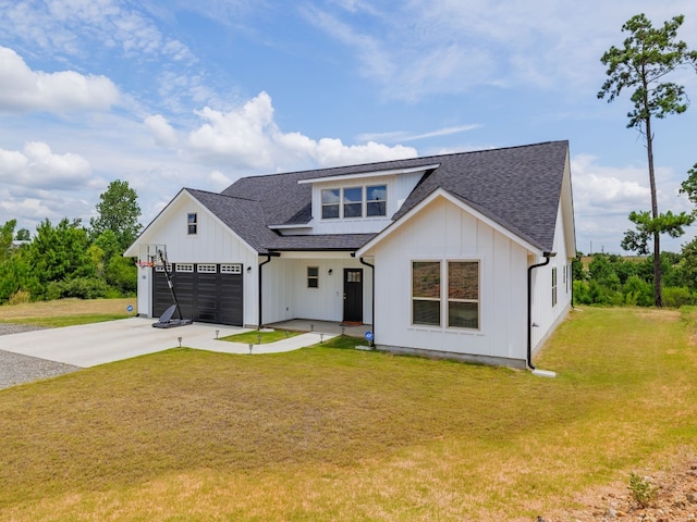 modern farmhouse with a front yard and a garage