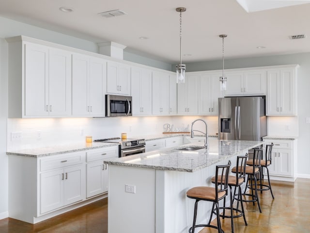 kitchen with white cabinets and appliances with stainless steel finishes