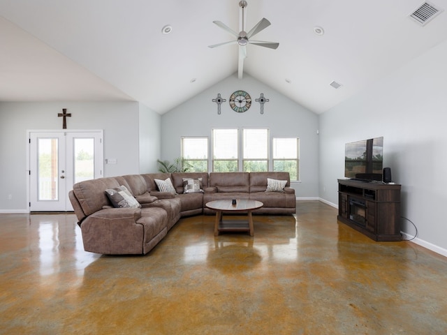 living room featuring ceiling fan, concrete flooring, high vaulted ceiling, and a healthy amount of sunlight