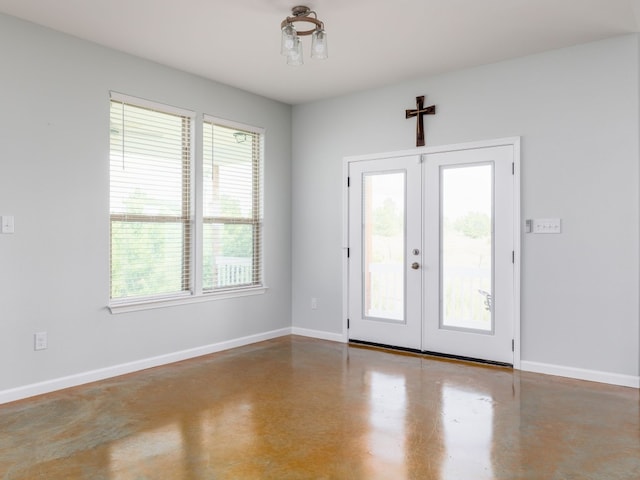 interior space with concrete floors and french doors