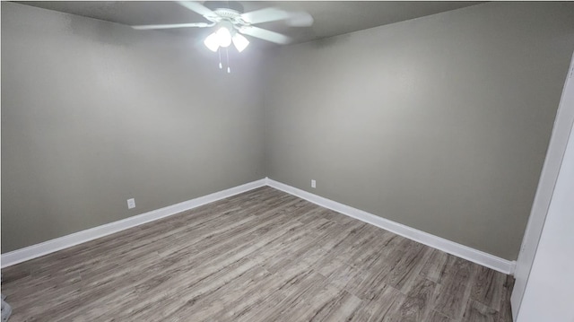 spare room featuring light hardwood / wood-style flooring and ceiling fan