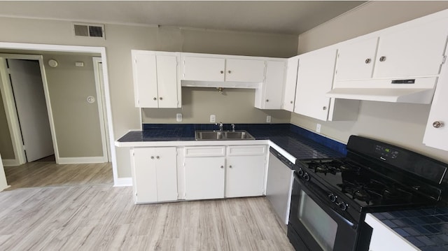 kitchen with black gas stove, light hardwood / wood-style floors, sink, and white cabinets