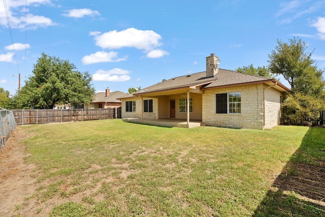 back of property featuring a lawn and a patio