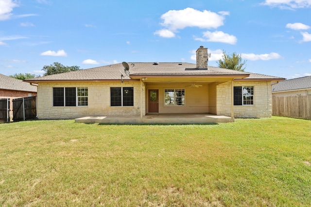 rear view of property with a lawn, a patio, and ceiling fan