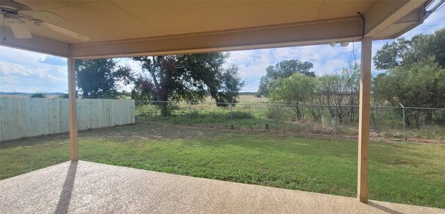 view of yard featuring ceiling fan and a patio area