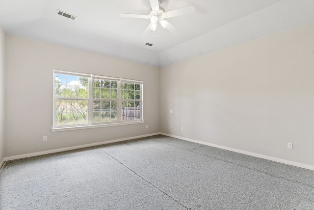 spare room featuring carpet floors, vaulted ceiling, and ceiling fan