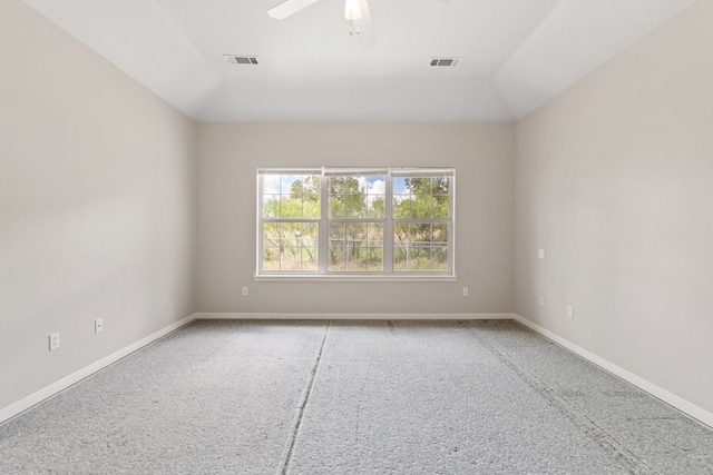 spare room with vaulted ceiling, ceiling fan, and carpet floors