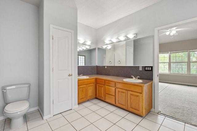 bathroom featuring tile patterned flooring, ceiling fan, vanity, and toilet