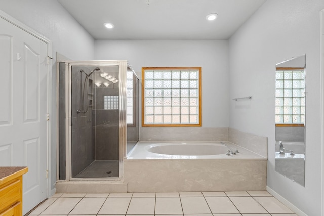 bathroom with vanity, plus walk in shower, and a wealth of natural light