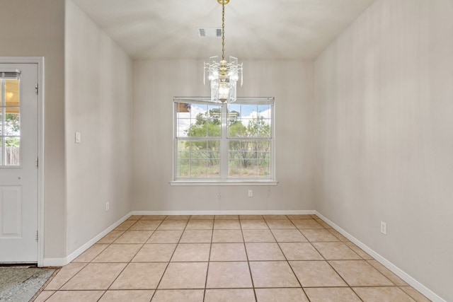 unfurnished dining area featuring an inviting chandelier and light tile patterned flooring