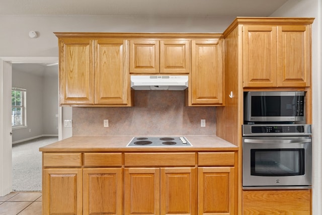 kitchen with stainless steel appliances and light tile patterned floors