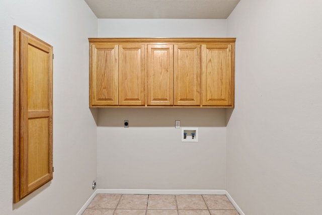 laundry room with light tile patterned flooring, hookup for an electric dryer, washer hookup, and cabinets