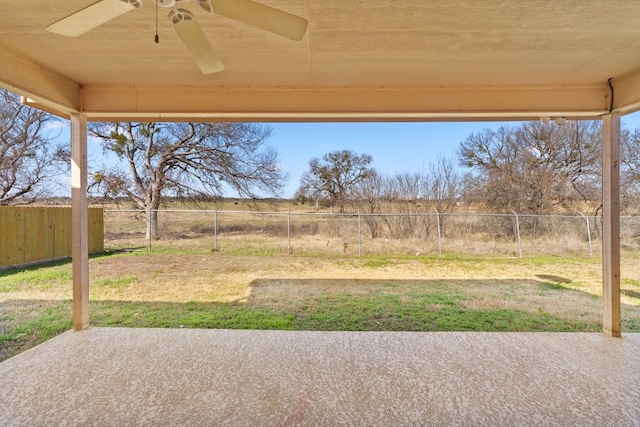 view of yard with ceiling fan and a patio area